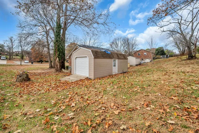 a view of a yard covered with snow in front of house