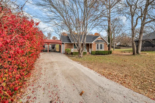 a front view of a house with a yard covered in snow