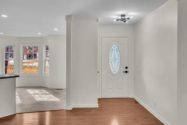 a view of an entryway with wooden floor