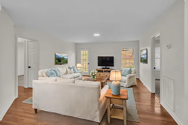 a living room with furniture and a flat screen tv