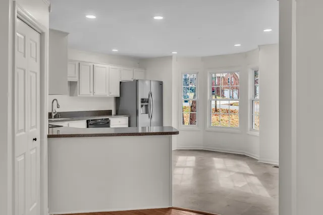 a kitchen with stainless steel appliances a refrigerator and a stove top oven