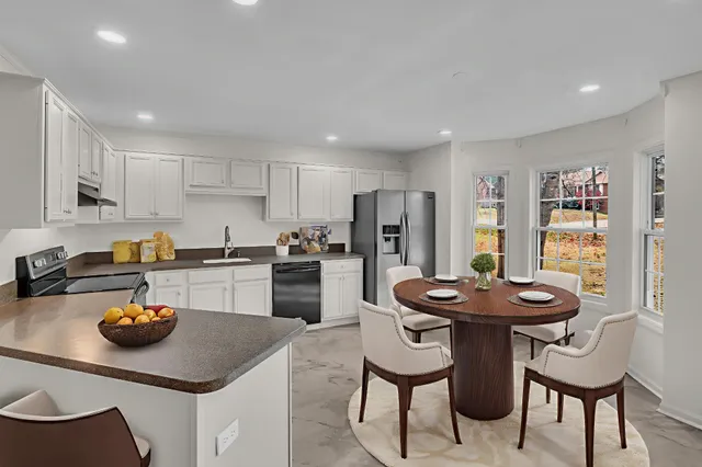 a kitchen with a sink a stove and chairs