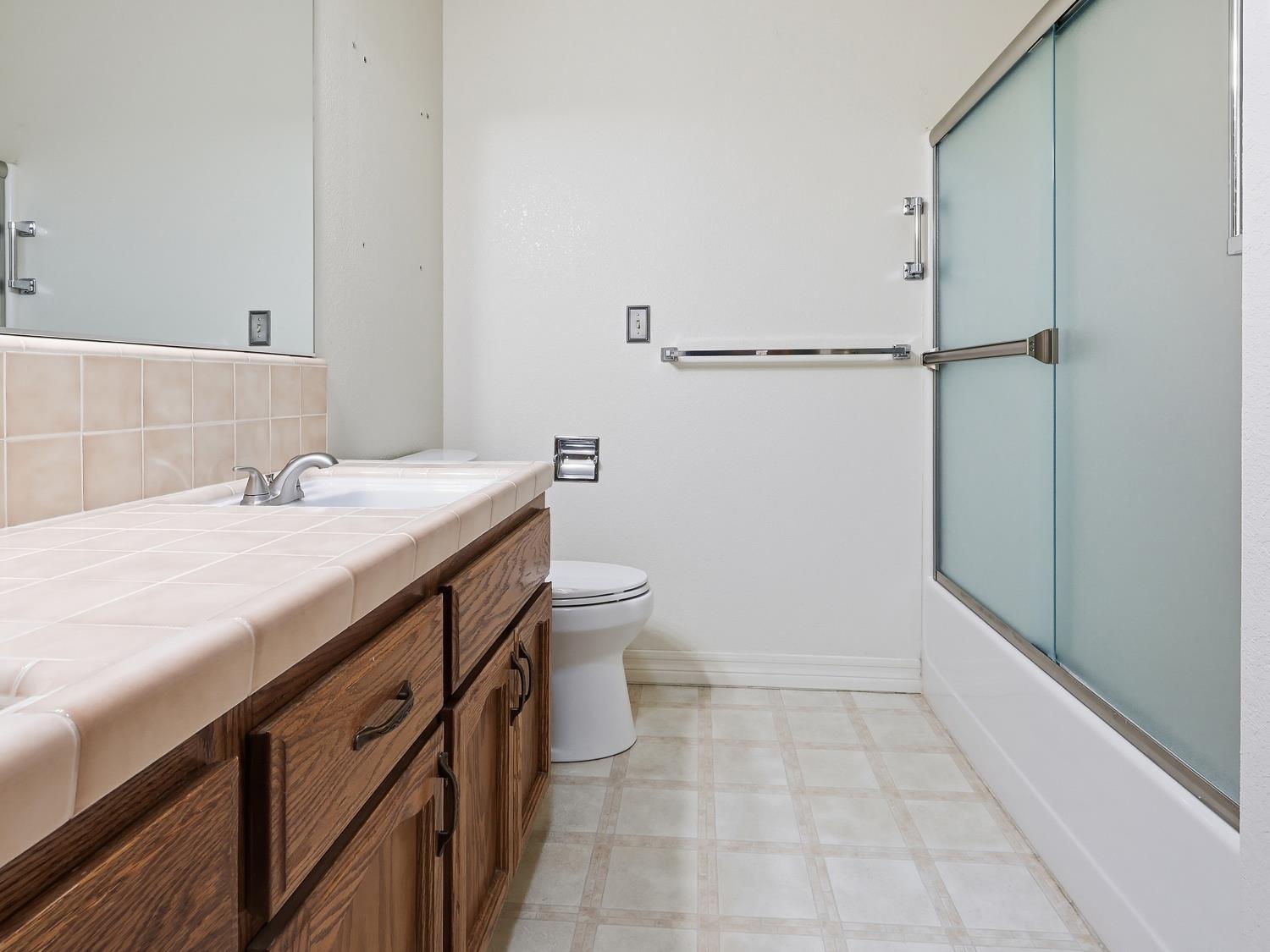 900 Multnomah Drive Modesto, CA 95350 - Photo 18 of 34 (Guest Bath)Double Vanity Sink with Updated Shower surround and Custom Built-in Skylight