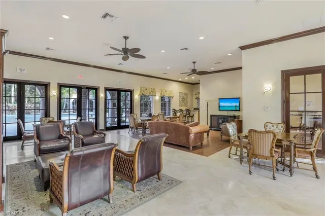 a living room with furniture kitchen view and a large window