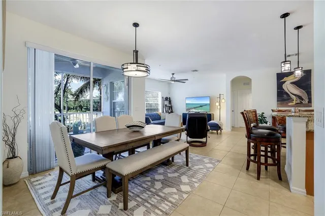 a dining room with furniture a chandelier and wooden floor