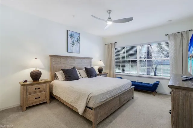 a bedroom with a bed and large window