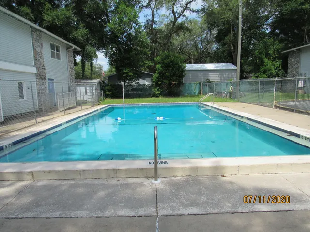 a view of a small pool with a yard