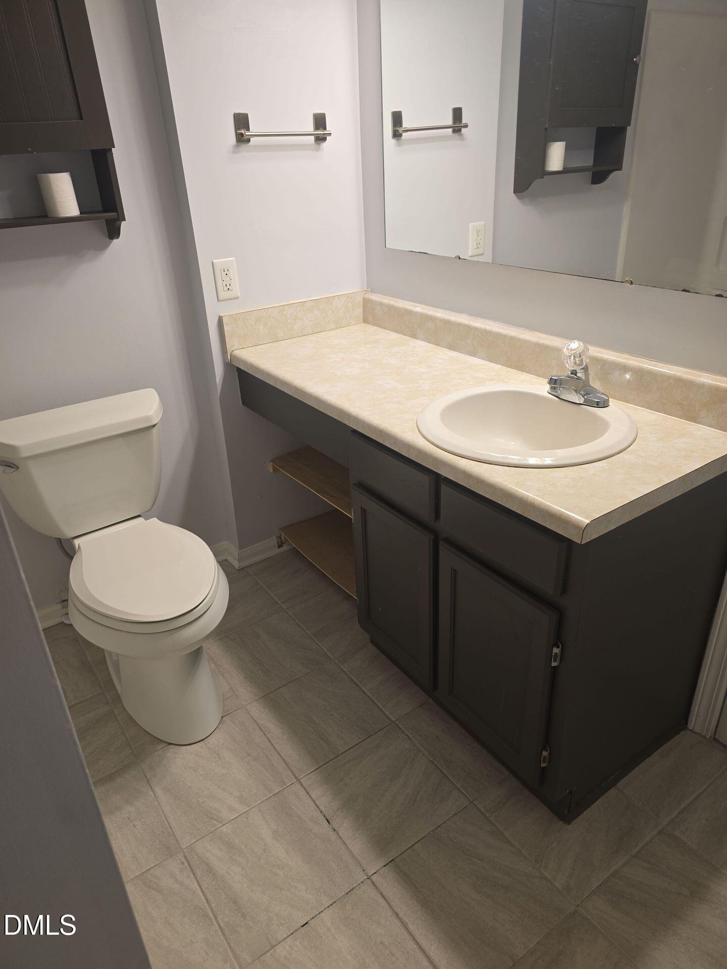 7825 Stephanie Lane Raleigh, NC 27615 - Photo 12 of 20 a bathroom with a sink toilet and mirror