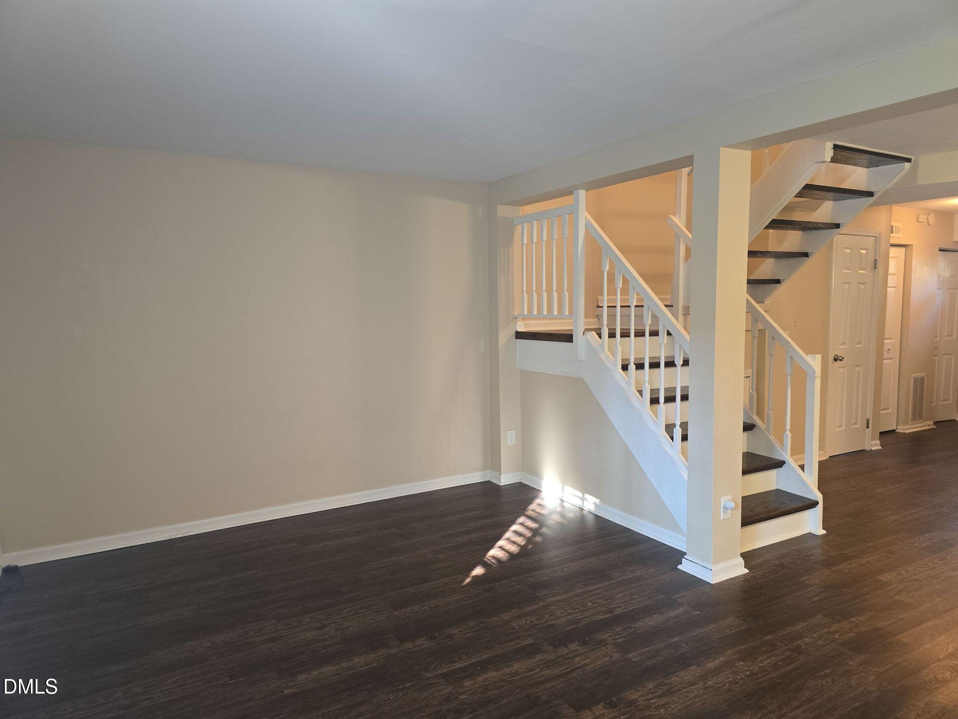 7825 Stephanie Lane Raleigh, NC 27615 - Photo 4 of 20 a view of entryway and hall with wooden floor