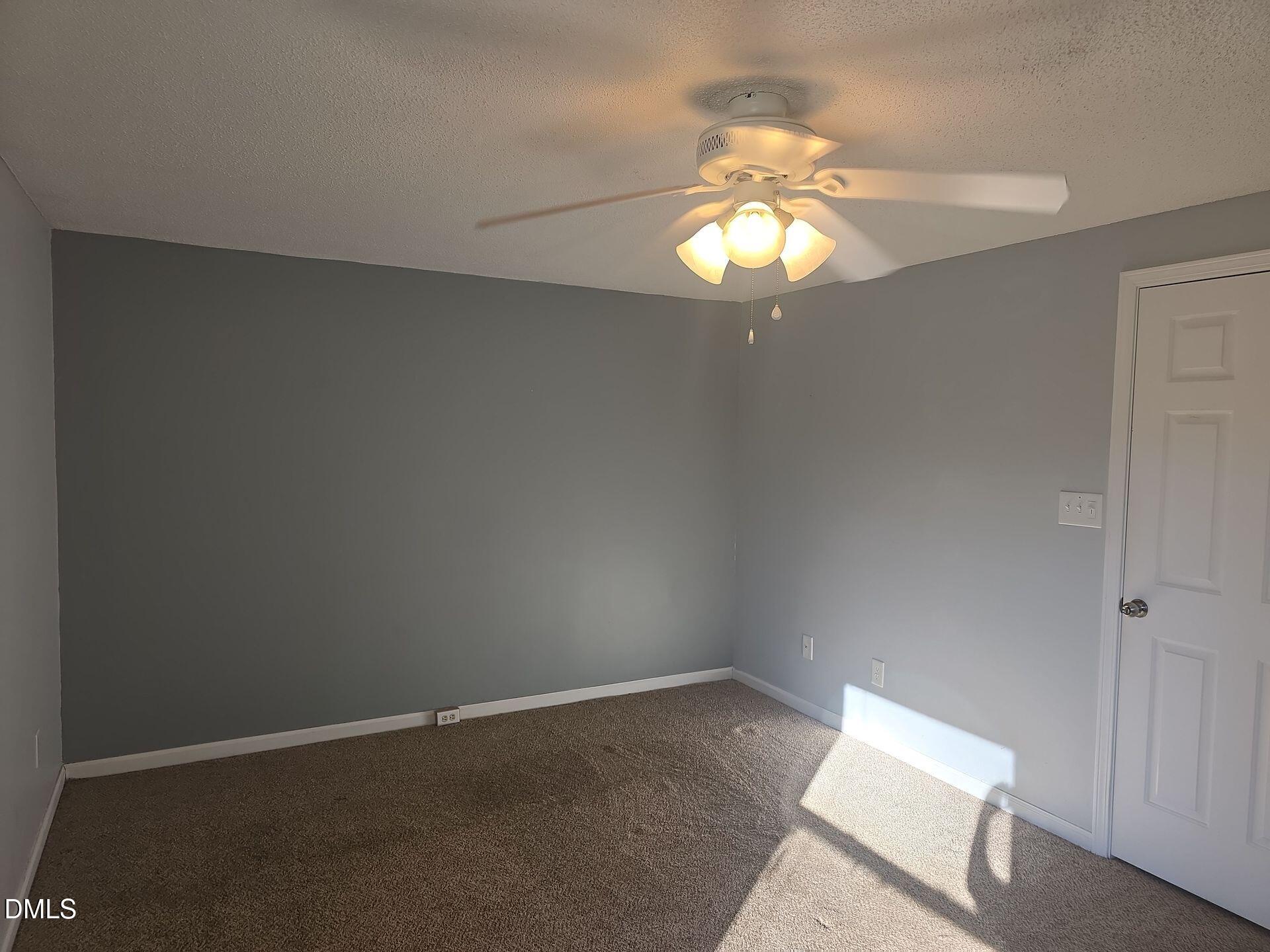 7825 Stephanie Lane Raleigh, NC 27615 - Photo 9 of 20 a view of a chandelier fan in a room