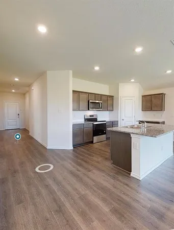 a view of kitchen with cabinets microwave and stove