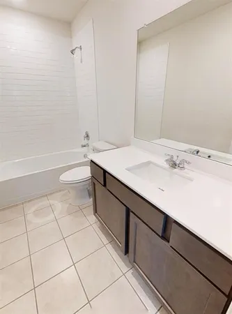 a bathroom with a sink a toilet and bathtub