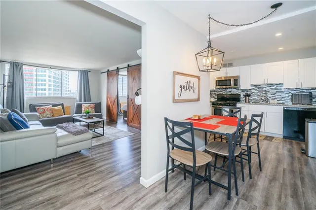 a view of a dining room with furniture window and wooden floor