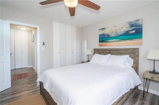 a bedroom with a bed and a painting on the wall