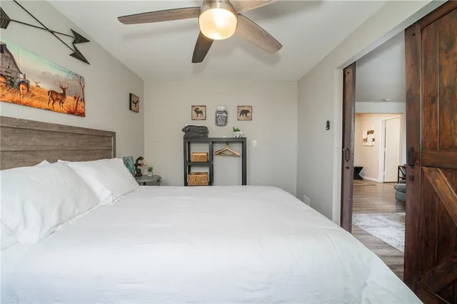 a bedroom with a bed and a chandelier