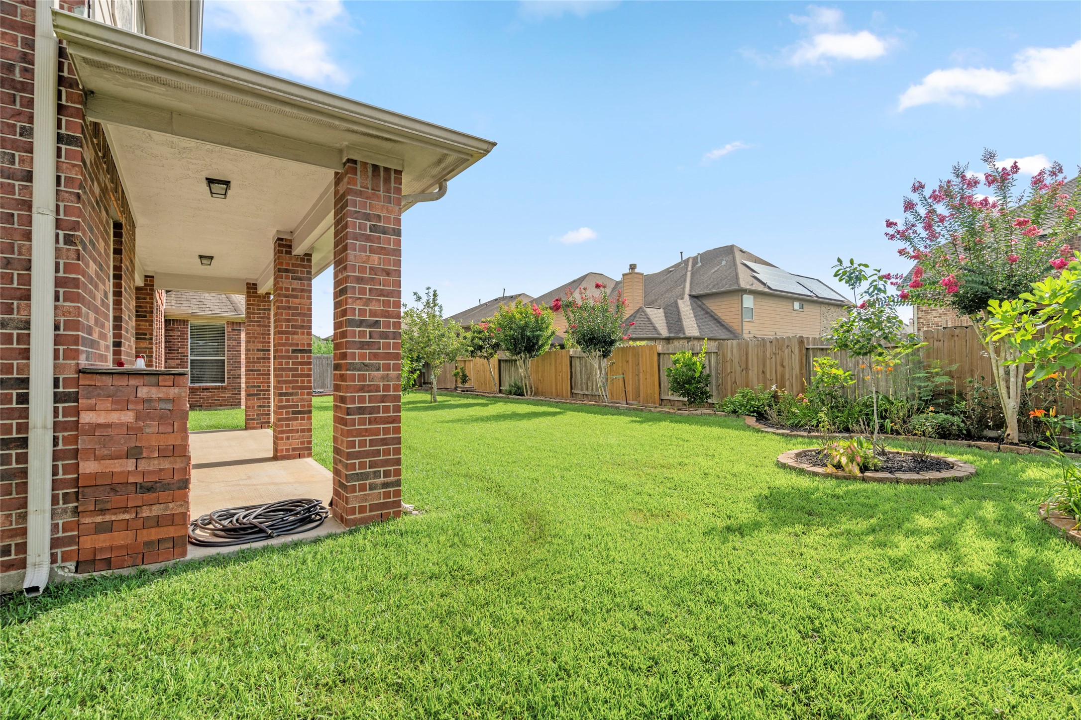 5307 Amber Sky Lane Rosharon, TX 77583 - Photo 43 of 50 The professionally manicured backyard unfolds with a lush green lawn and mature, fruit-bearing trees a private outdoor oasis ready to enjoy.