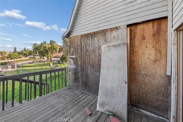 a balcony with wooden floor and fence