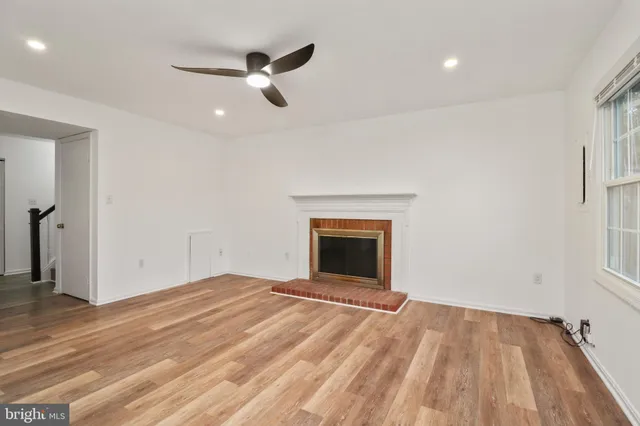 wooden floor in an empty room with a fireplace