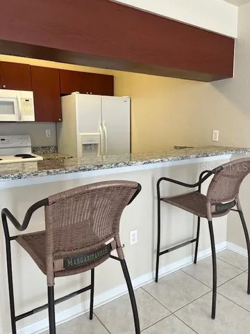 a view of a kitchen counter space and dining room