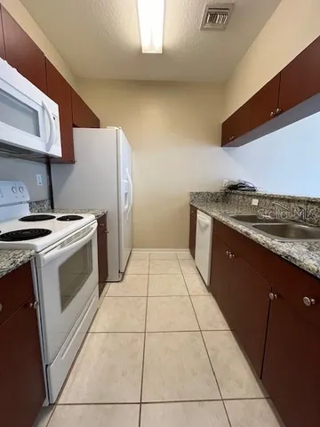 a kitchen with a stove top oven and cabinets