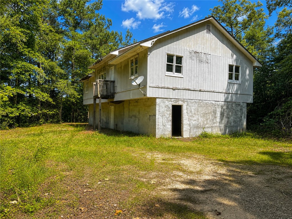 597 Old Hurricane Road Westminster, SC 29693 - Photo 3 of 11 Perched among verdant trees, this property features a private yard with ample green space.
