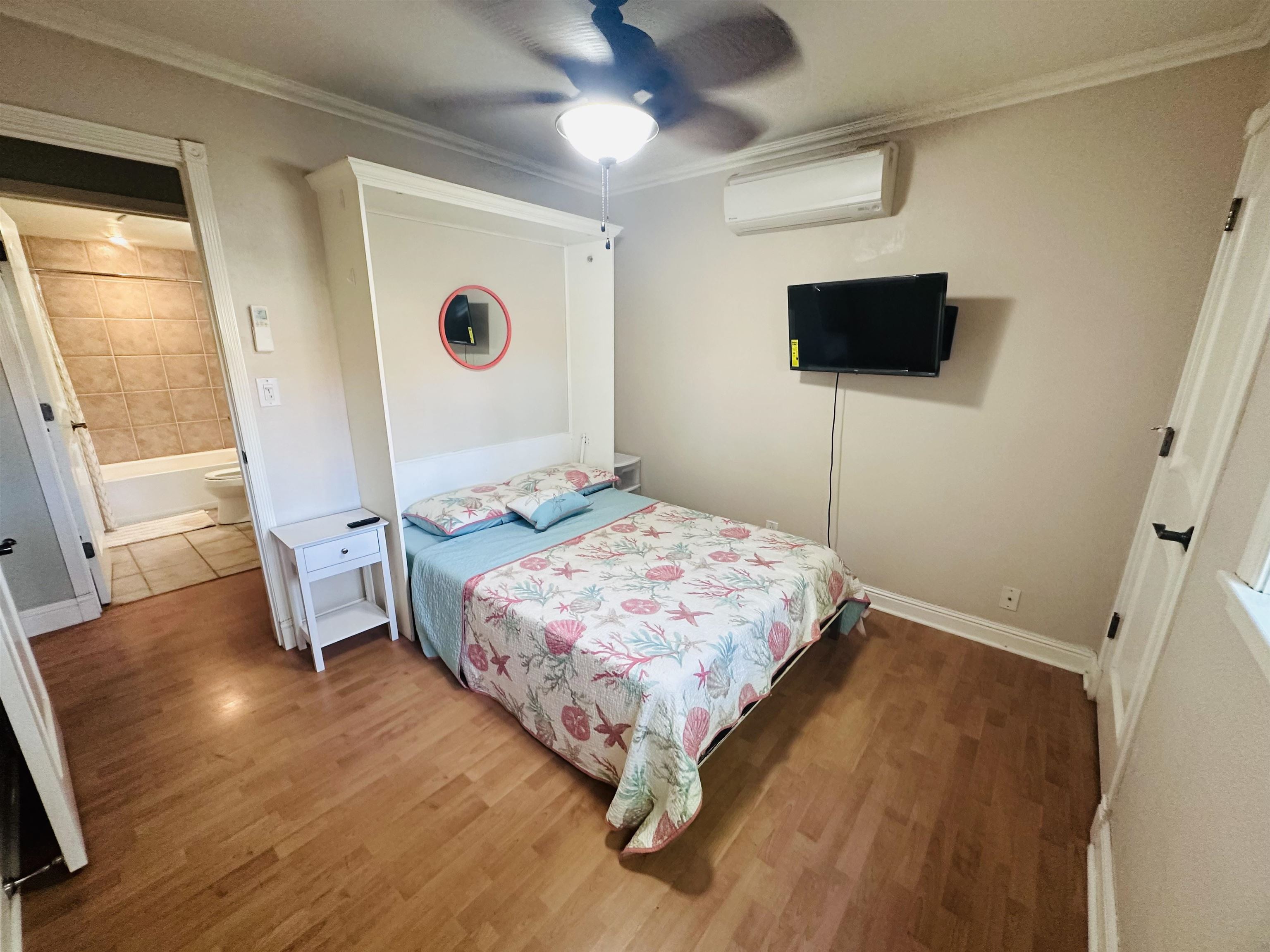 140 Uwapo Road, Unit 6101 Kihei, HI 96753 - Photo 4 of 19 a bedroom with a bed and a flat screen tv