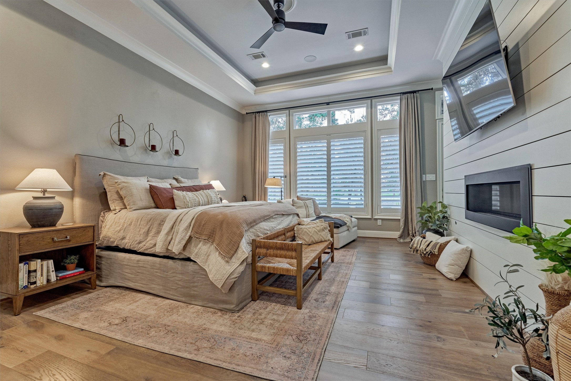 4463 Lily Bean Road Montgomery, TX 77316 - Photo 24 of 45 Making a statement all it's own, the primary suite features a wood flooring and added ceiling fan (July 2024) and gas fireplace.
