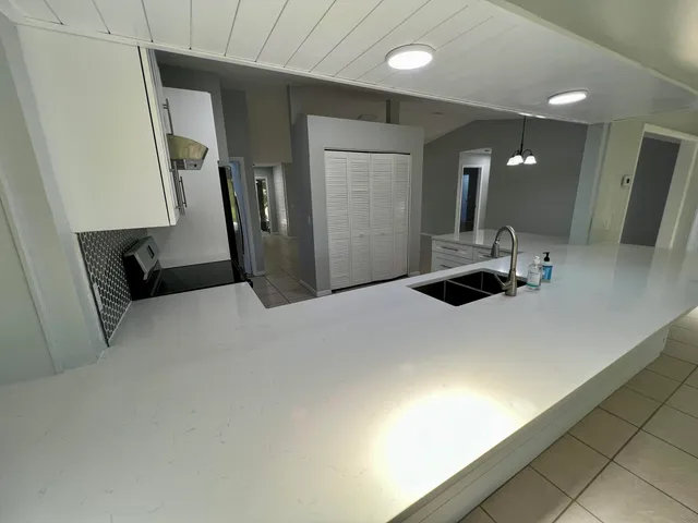 a large white bed in a bathroom