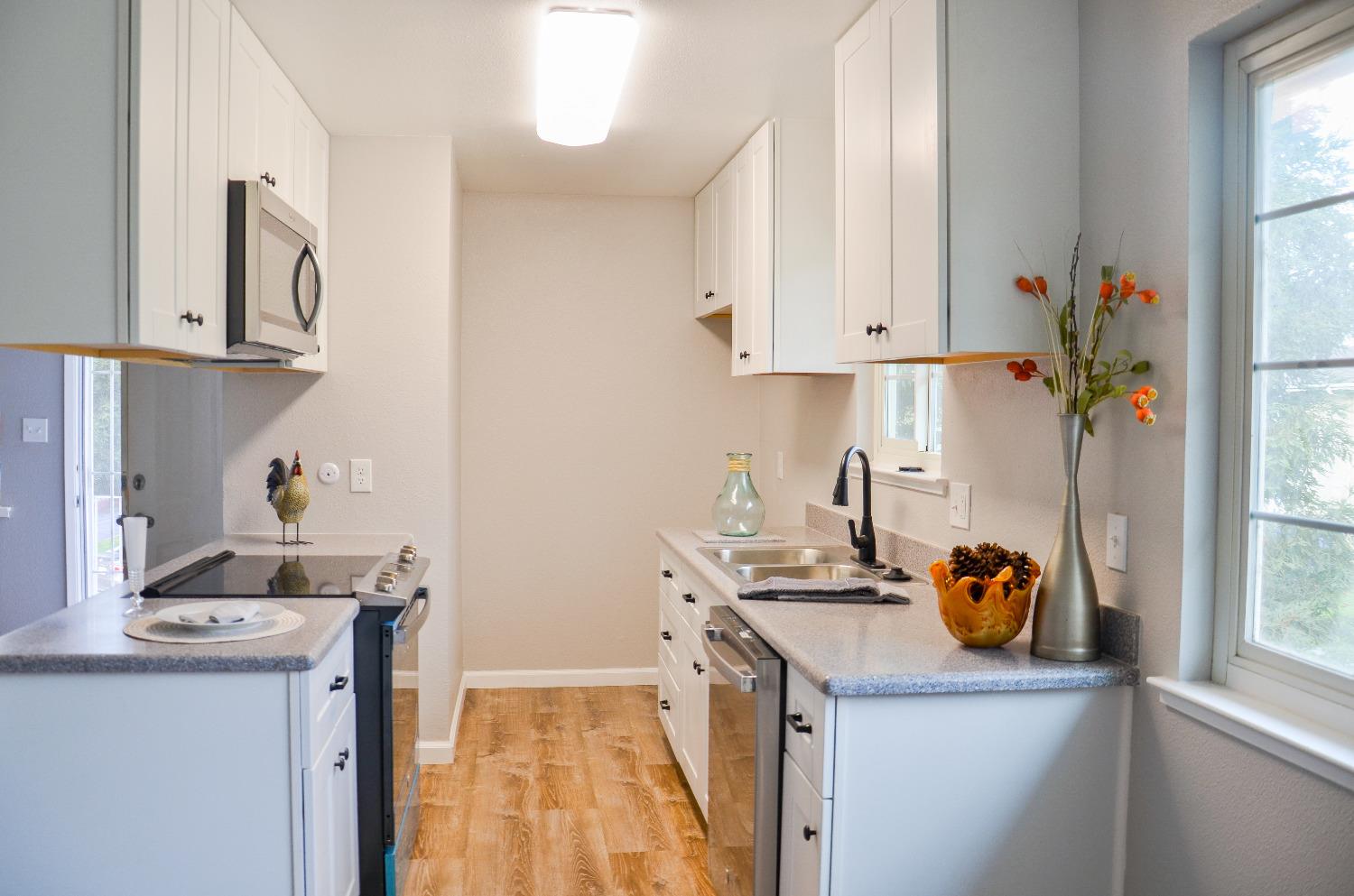 2320 Peach Avenue, Unit 4 Clovis, CA 93612 - Photo 4 of 14 a kitchen with a sink cabinets and window