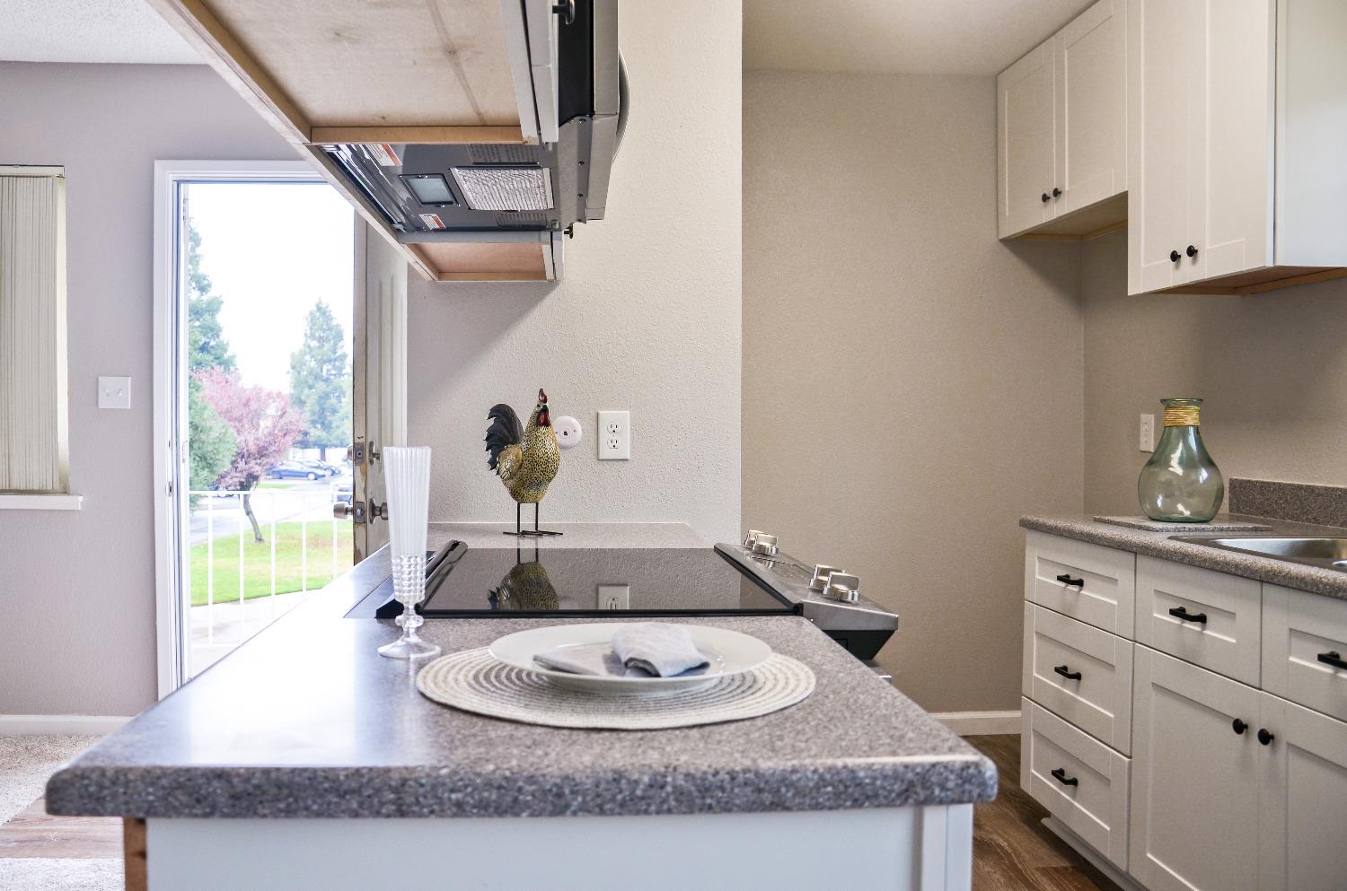 2320 Peach Avenue, Unit 4 Clovis, CA 93612 - Photo 5 of 14 a bathroom with a granite countertop sink a mirror and vanity