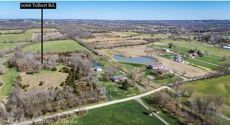 2066 Tolbert Road Hamilton, OH 45011 - Photo 61 of 63 Expansive rural landscape features a pond and scattered residential structures amidst verdant fields.