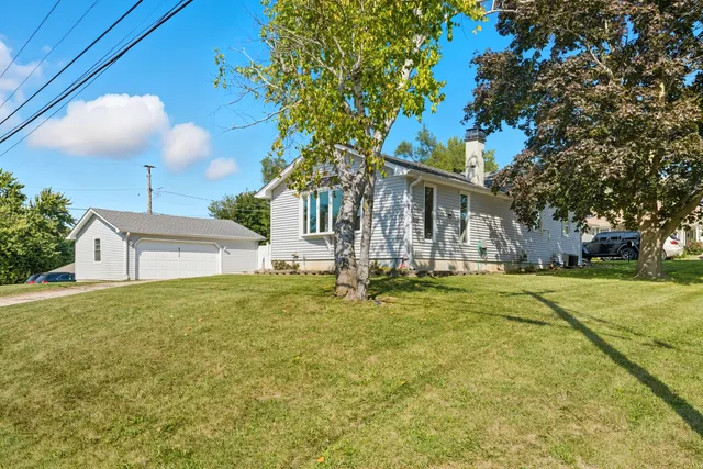 a front view of house with yard and trees