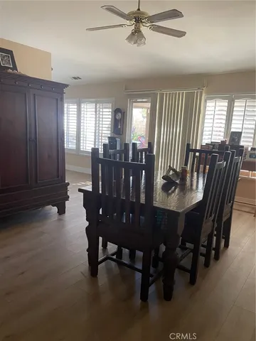 a view of a dining room with furniture and window