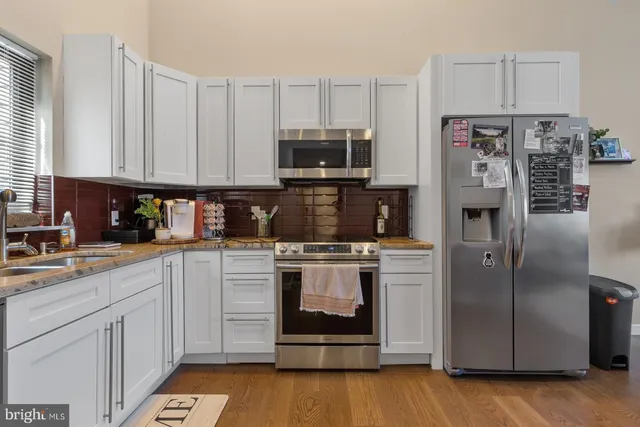a kitchen with a stove and a refrigerator