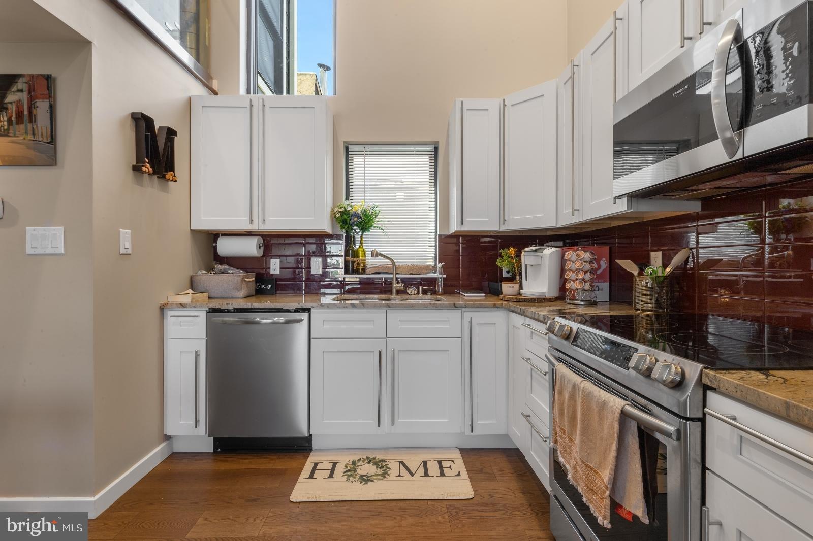 1142 Crease Street, Unit 2L Philadelphia, PA 19125 - Photo 3 of 17 a kitchen with stainless steel appliances granite countertop a stove a sink and a microwave
