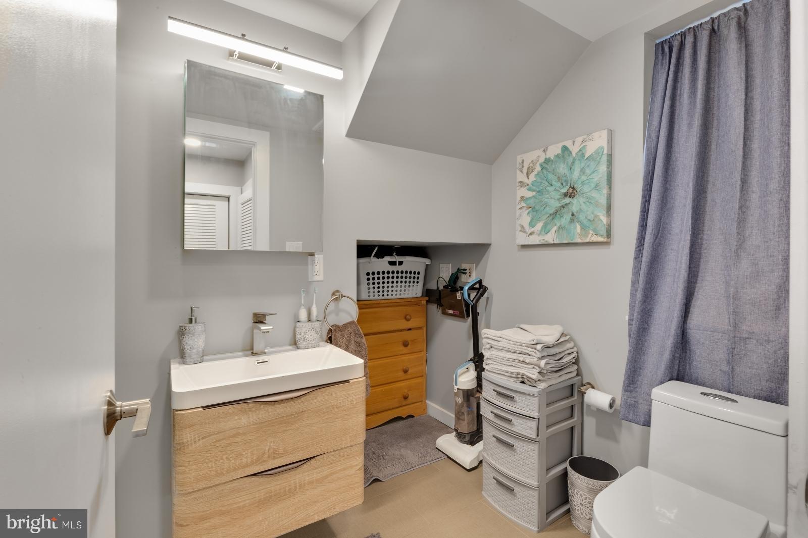 1142 Crease Street, Unit 2L Philadelphia, PA 19125 - Photo 9 of 17 a bathroom with a sink toilet vanity and tub