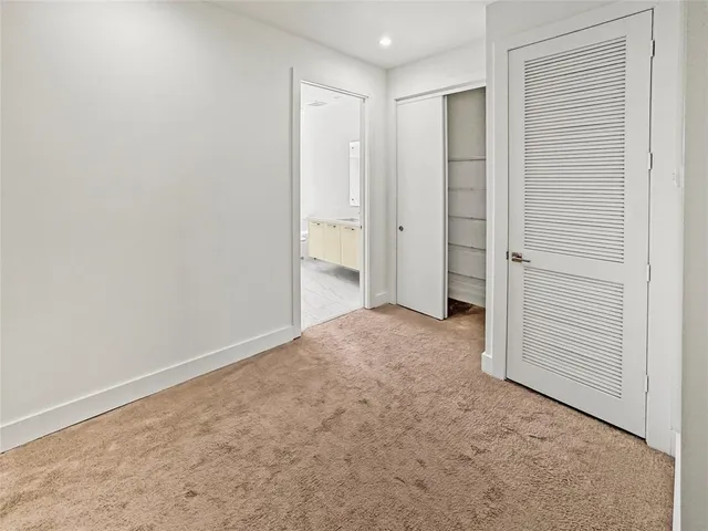 a view of a bedroom with washer and dryer