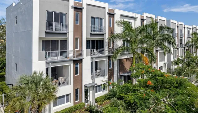 a front view of a multi story building with a yard