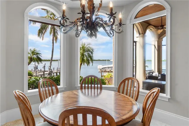 a view of a dining room with furniture a chandelier and wooden floor