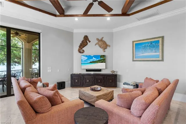 a living room with furniture a large window and a flat screen tv