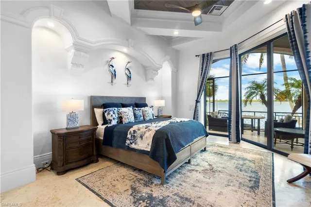 a bedroom with a large bed and a window