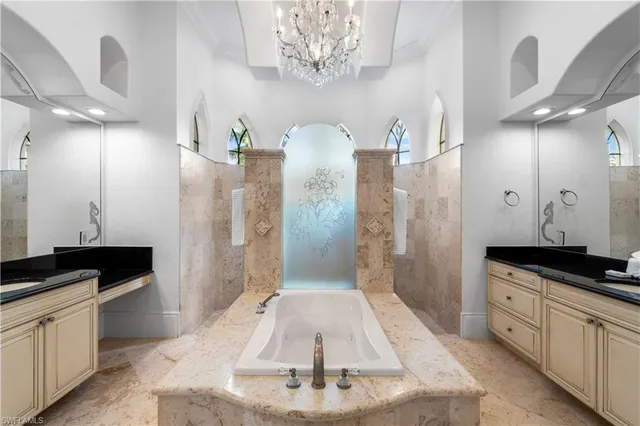 a spacious bathroom with a granite countertop sink a mirror and shower