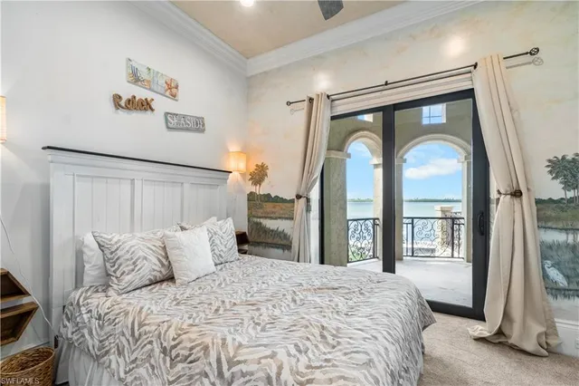 a bedroom with a large bed and a large mirror next to a window