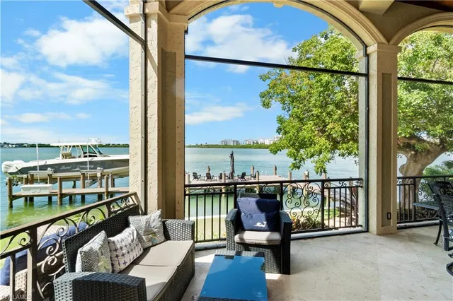 a view of a balcony with chairs and a floor to ceiling window