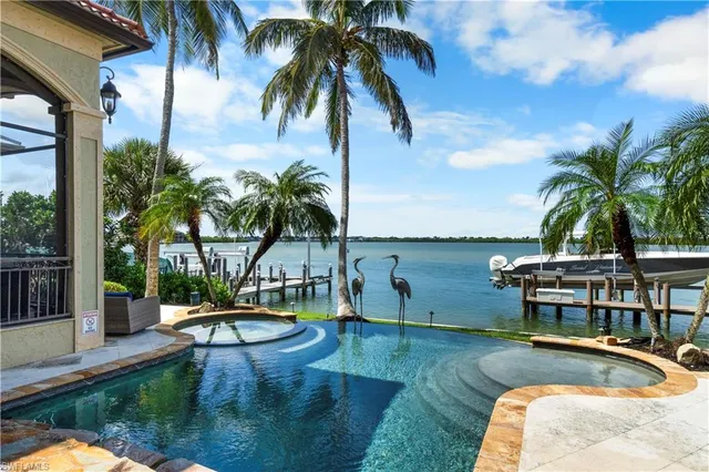 a view of a swimming pool with a table and chairs