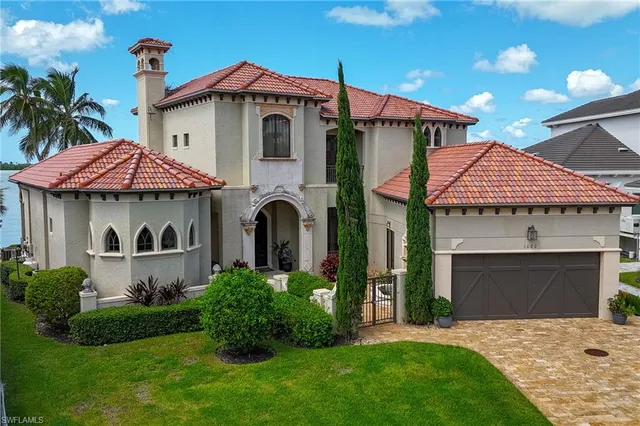 a front view of a house with a garden and plants