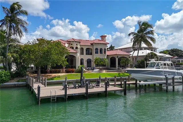 a view of a house with pool and chairs