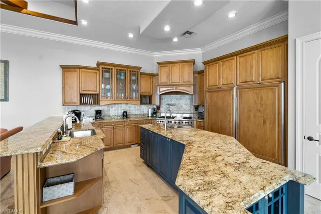a kitchen with stainless steel appliances granite countertop a sink stove and refrigerator