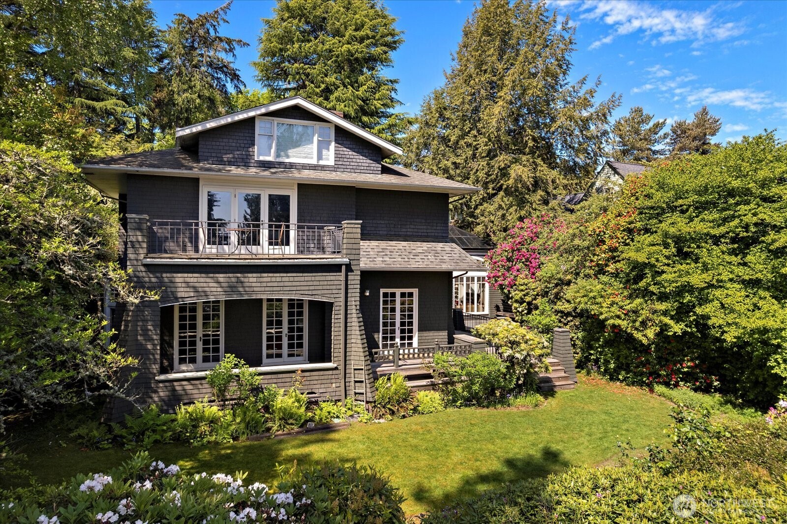3802 East John Street Seattle, WA 98112 - Photo 1 of 36 a front view of a house with a yard