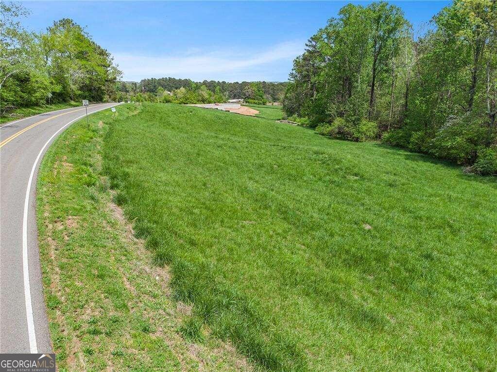 144 Long Road, Unit TRACT 4 Ball Ground, GA 30107 - Photo 1 of 1 a view of a green field with lots of bushes